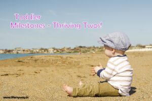 toddler sitting on beach